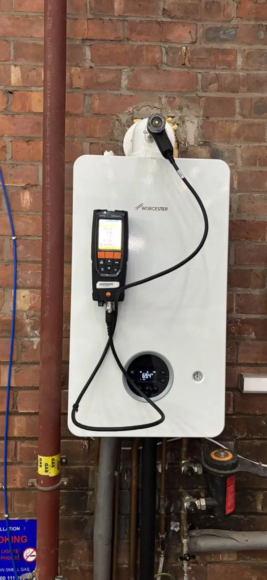 Worcester boiler being checked with a flue gas analyser connected to its flue test point